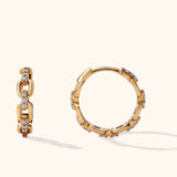Close-up of 14K gold pavé chain link hoop earrings with mini huggie silhouette and CZ stones, shown front and side view