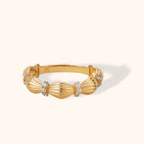 Textured 14K gold ribbed band ring featuring rounded segments separated by diamond-set dividers