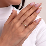 Close-up of a woman's hands showcasing a unique 14K gold ring with ribbed spherical elements, offering a bold yet refined style.