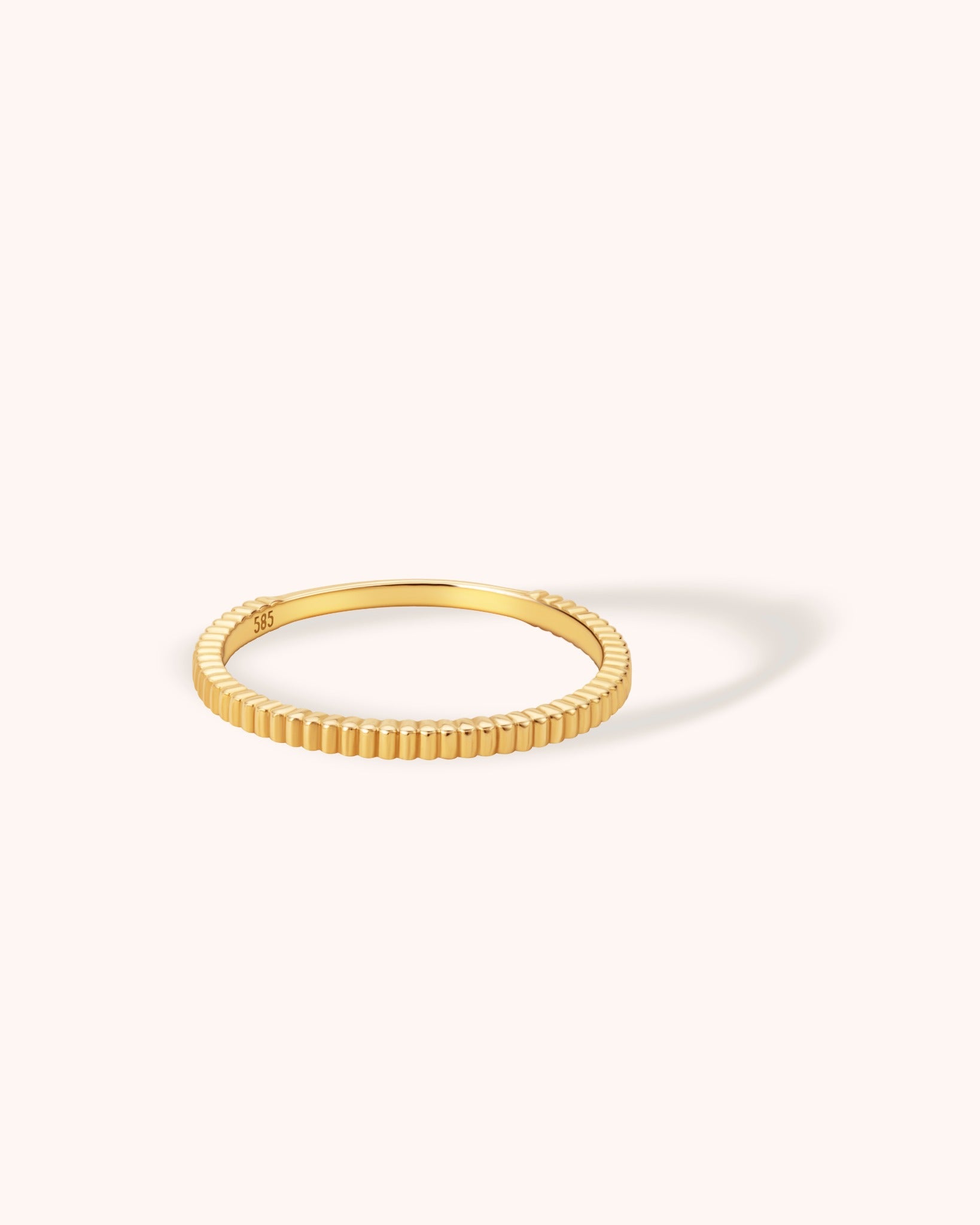 14K yellow gold ring with full ribbed texture and minimalist design