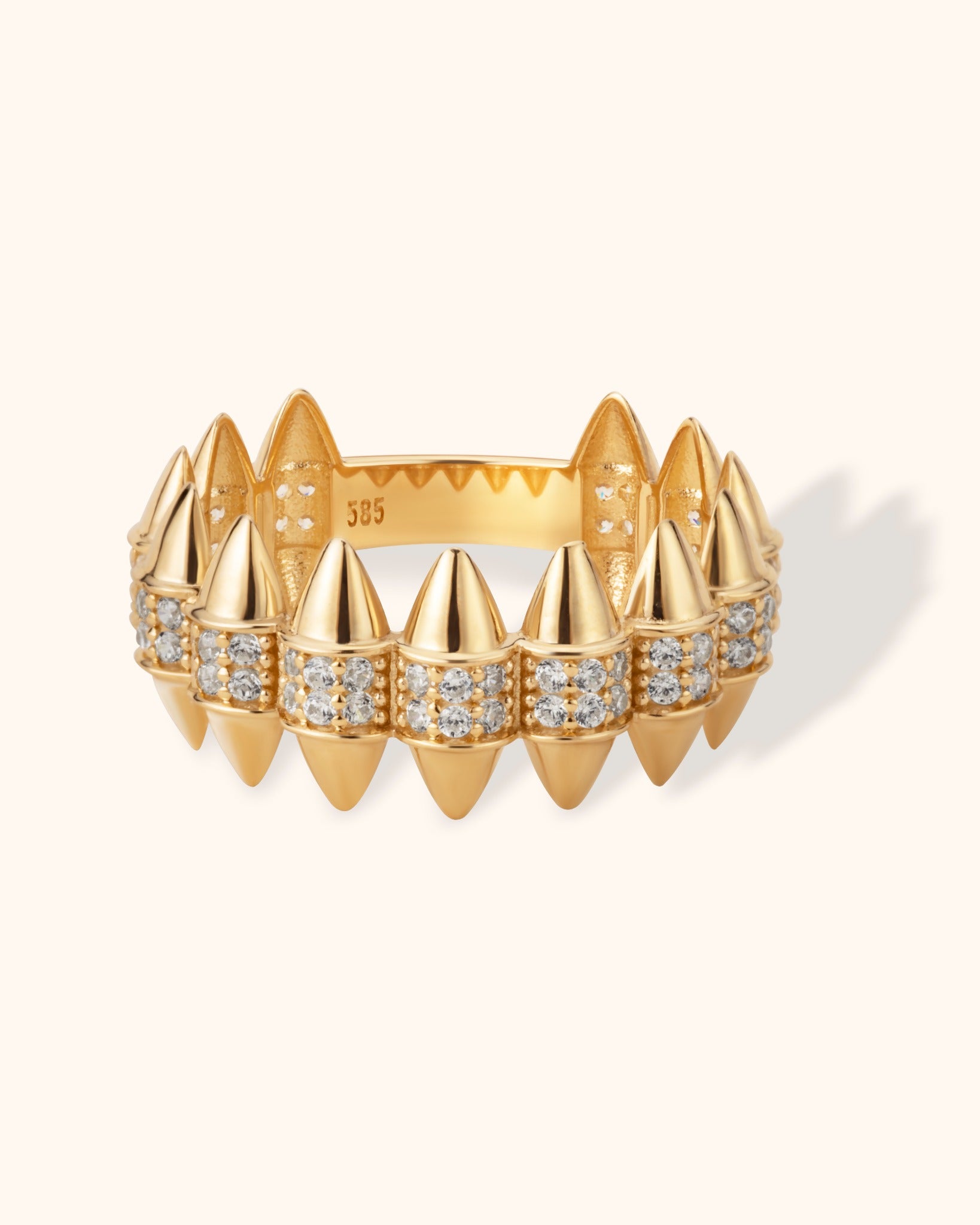 14K gold spiked ring with pavé cubic zirconia, modern edgy jewelry design on cream background.
