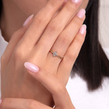 Gold ring with star-shaped zircon worn on finger, celestial-inspired minimalist jewelry