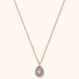 14K gold teardrop pendant necklace with halo diamonds and baguette center