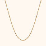 Minimal 14K gold necklace with bead-textured design and elegant shine