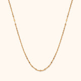 Minimal 14K gold necklace with bead-textured design and elegant shine