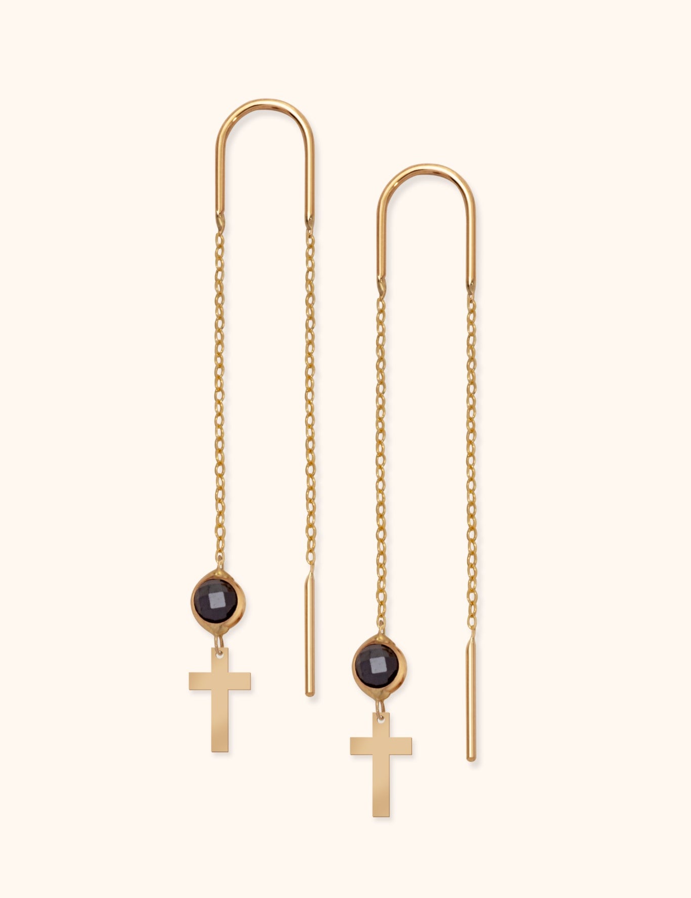 14k gold threader earrings with black round crystal and cross charm on soft background

