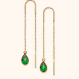 14k gold threader earrings with green teardrop crystal on neutral background

