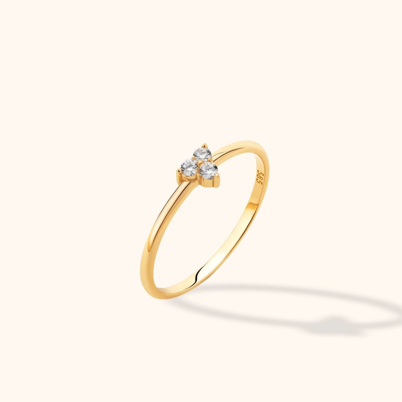 14K gold minimalist ring with three round diamonds in a clustered setting on a thin band