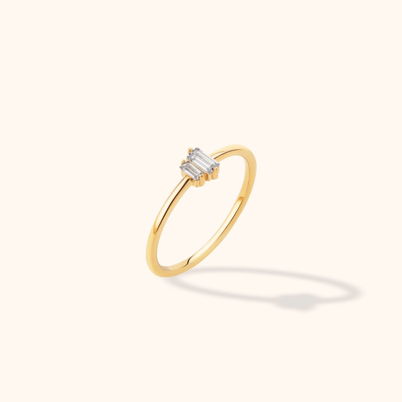 14K yellow gold ring featuring a row of baguette-cut diamonds in a minimalist and stackable design.