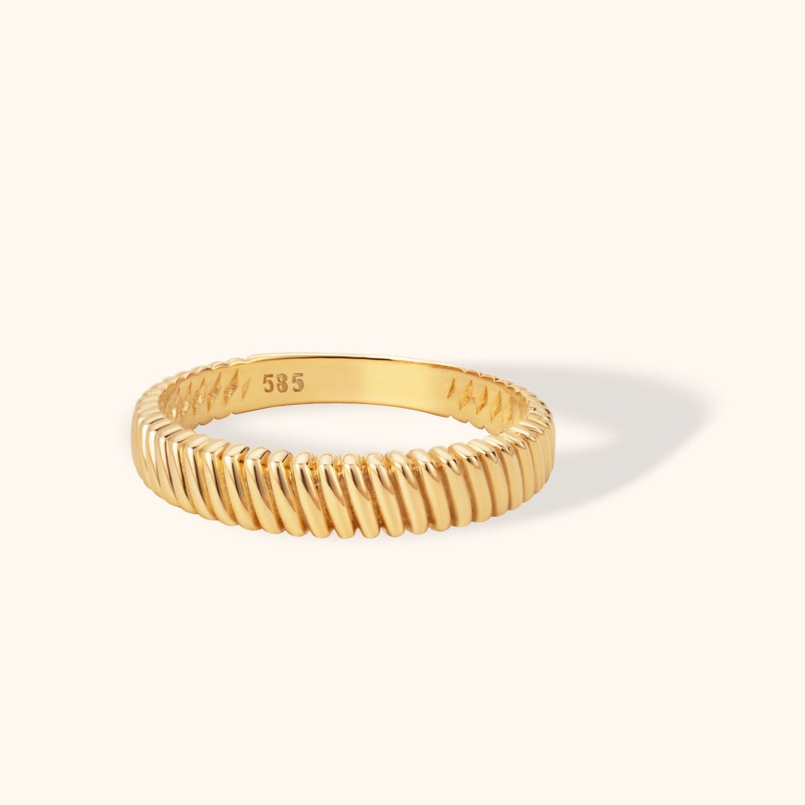 14K yellow gold band ring with twisted groove texture and polished finish