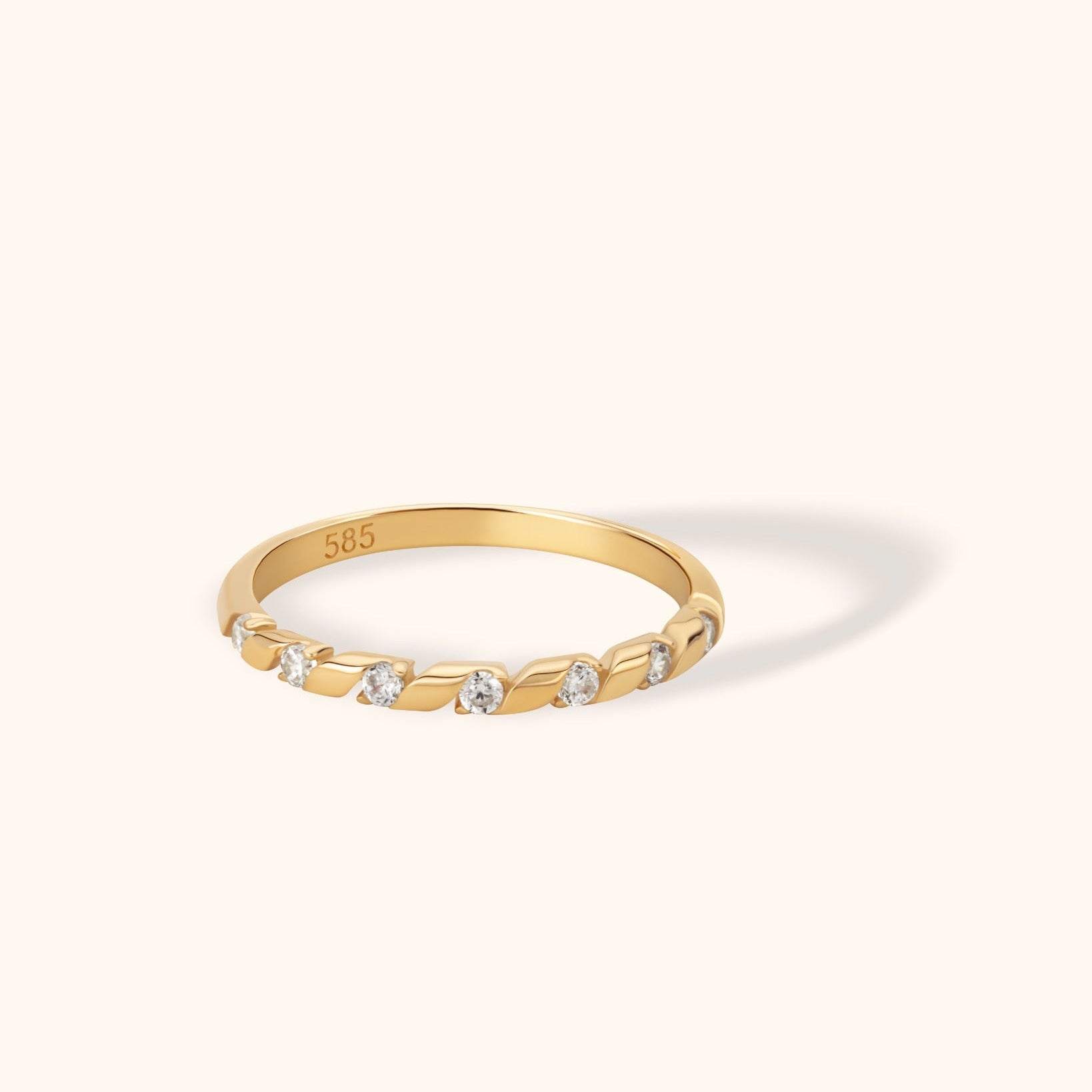 14K gold ring with twisted groove design and round zircon stones set along the band