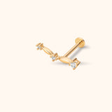 Close-up of 14K solid gold chevron tragus stud earring with three clear sparkling crystals in a minimalist flat-back design.