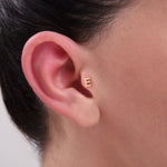 Minimal gold initial piercing with the letter E – personalized ear jewelry