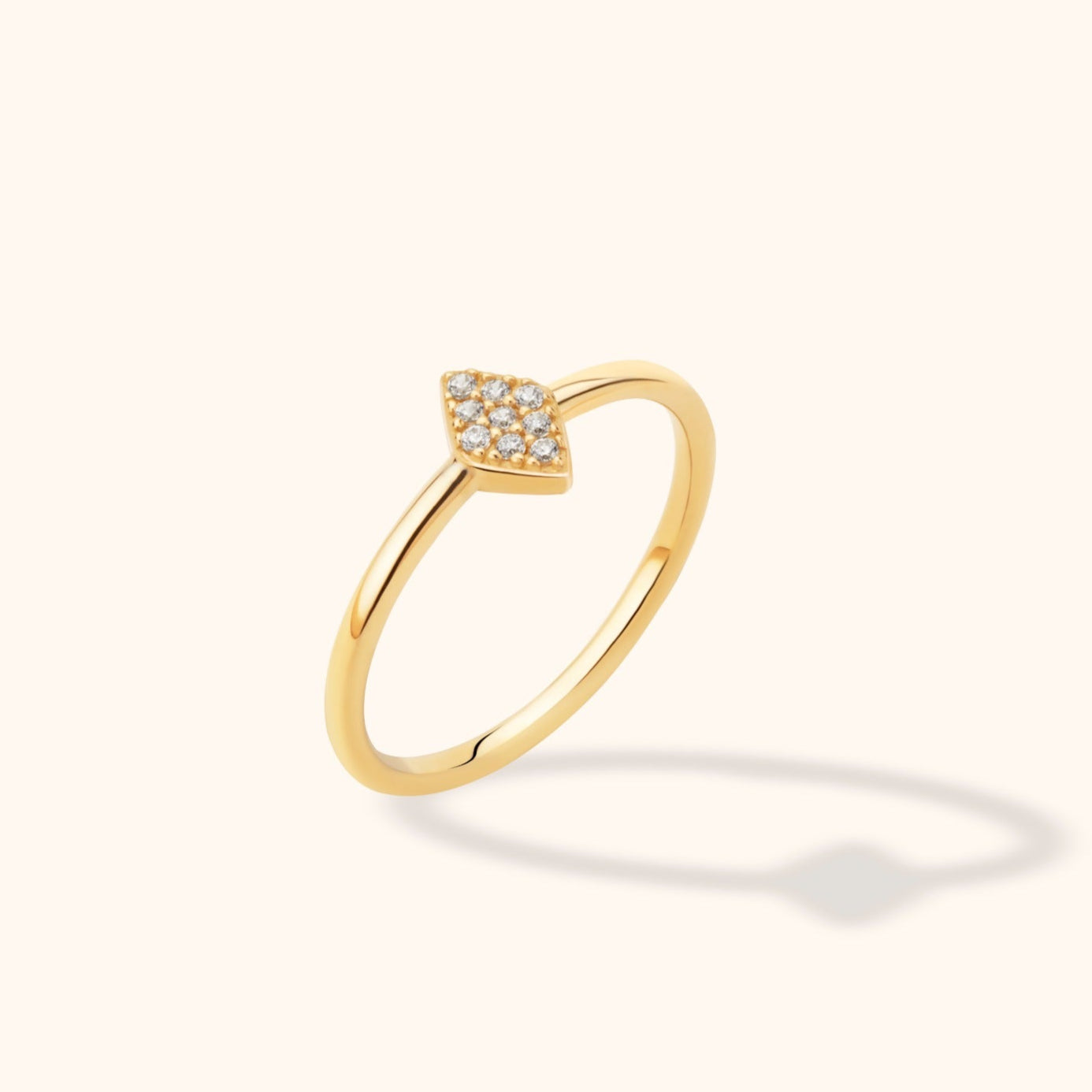 14K yellow gold band ring with a marquise-shaped pave diamond cluster on a neutral background