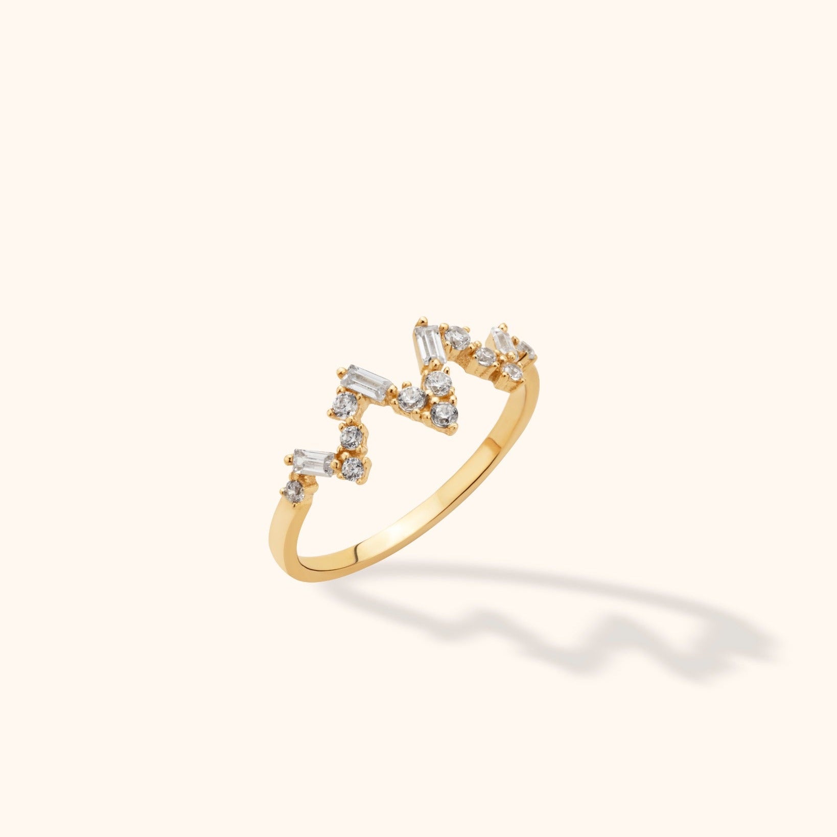 14K yellow gold open band ring with zigzag pattern of baguette and round diamonds