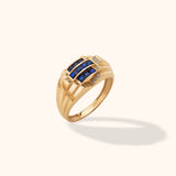 14K yellow gold men’s ring with channel-set blue sapphire rows and diamond accents on a neutral background