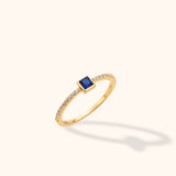 14K yellow gold open band ring with square blue sapphire center and diamond pavé shoulders