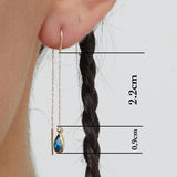 14K gold threader earrings with pear-shaped blue sapphire gemstones on fine gold chain