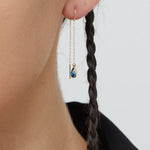 14K gold threader earrings with pear-shaped blue sapphire gemstones on fine gold chain