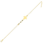 14K gold bracelet with maple leaf charm and gemstone accents on green satin