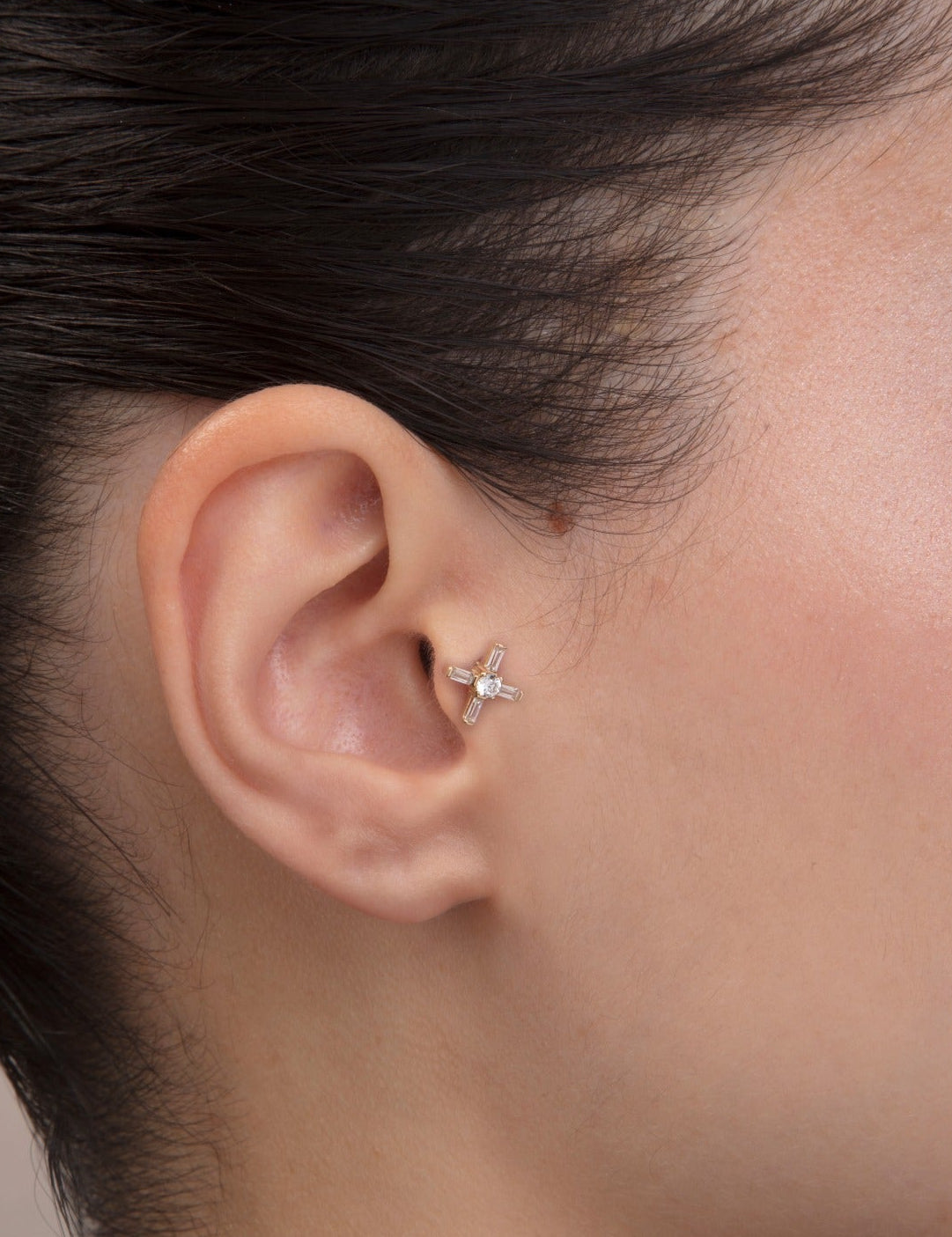 ear model wearing 14k gold baguette cz tragus earring cartilage piercing