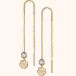 Pair of gold-tone threader earrings with fine chains, clear faceted accents, openwork flower charms and slim bar ends.