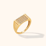 Gold-toned ring with five parallel rows of small clear stones and open slits along the shoulders, shown at an angle.