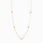 Minimalist 14K solid gold necklace with round beads spaced along a fine chain,