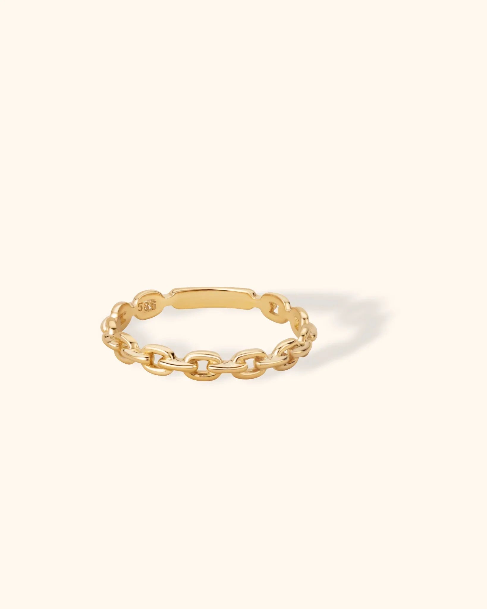 14K solid gold ring with chain link design on light beige background