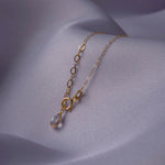 14K gold bracelet with two cross charms and a textured circular centerpiece