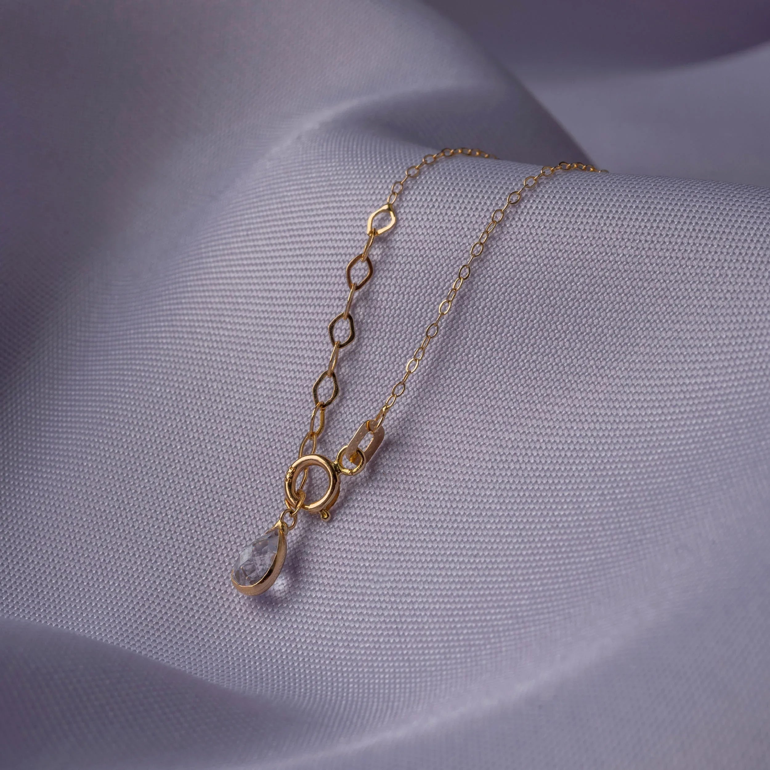14K gold bracelet with two cross charms and a textured circular centerpiece