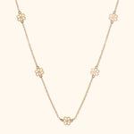 14K gold necklace with open flower station charms evenly spaced on delicate chain
