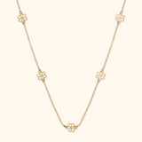 14K gold necklace with open flower station charms evenly spaced on delicate chain