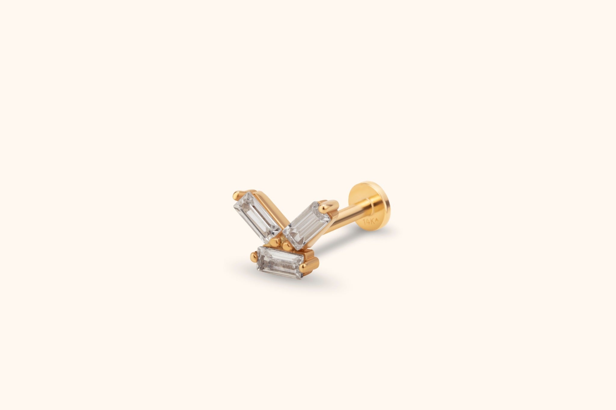 Gold-tone stud earring with three clear rectangular stones in a geometric cluster, a straight post and a flat round back.
