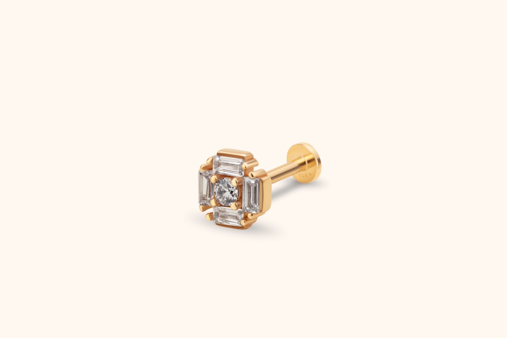 Gold-toned flat-back stud with a round clear center stone framed by four rectangular clear stones, shown at an angle.