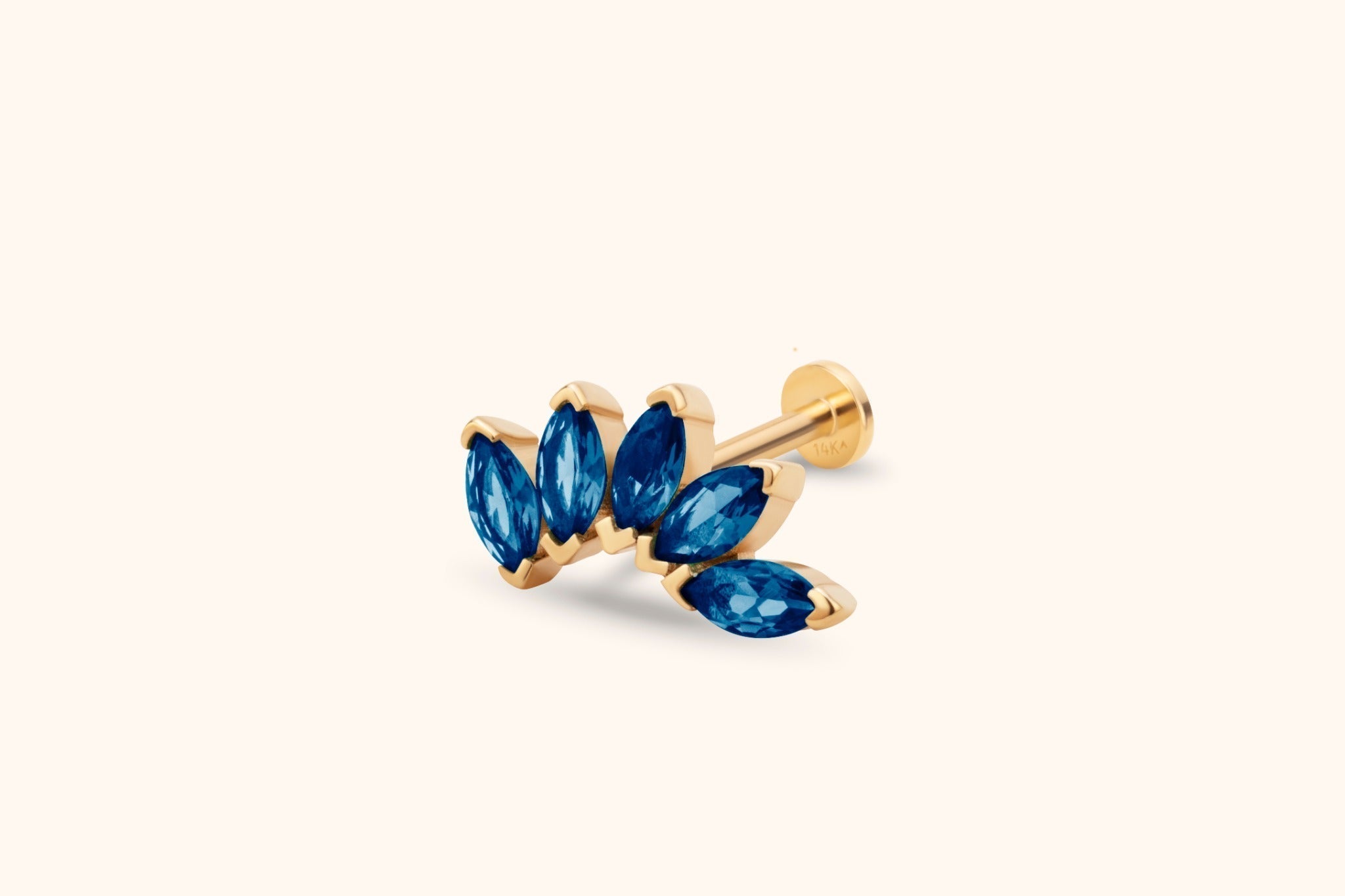 Gold-toned stud earring with five blue marquise-shaped stones in a curved leaf-like cluster, a straight post and flat round back.