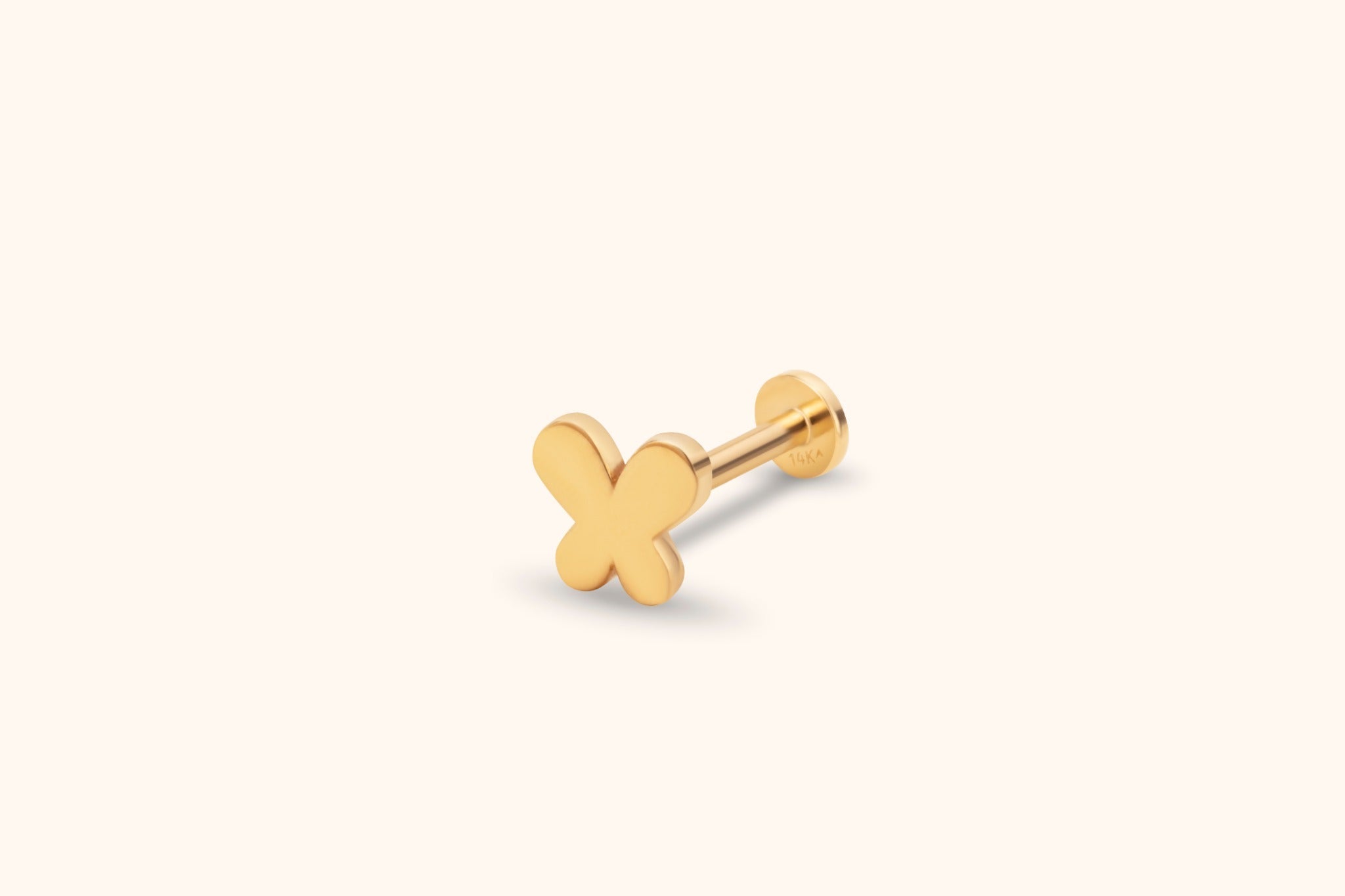 Gold-colored stud with a smooth butterfly-shaped front, straight post and round flat back on a pale cream background.