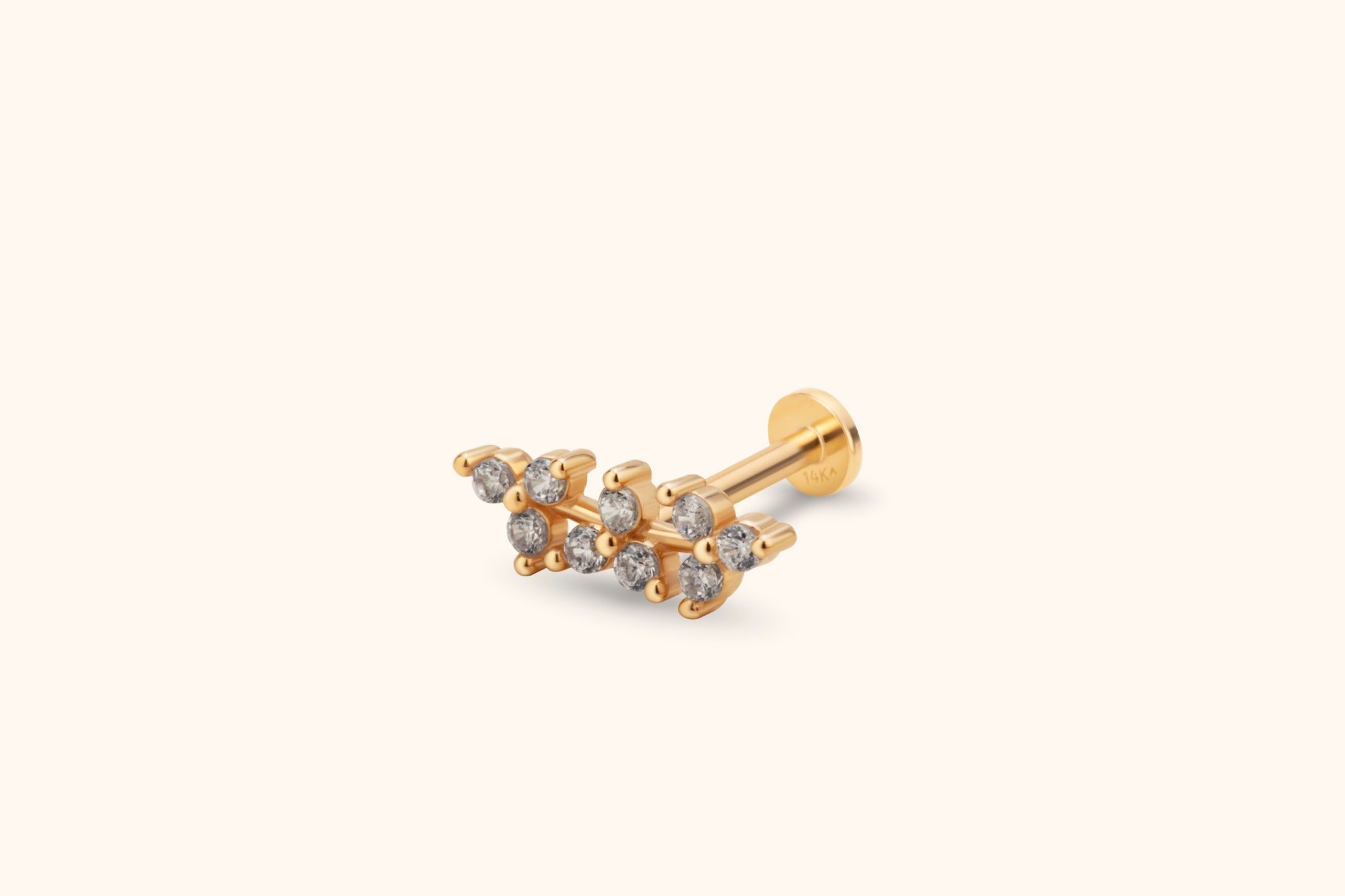 Gold-colored stud earring with two staggered rows of round clear stones, a straight post and a flat circular back.