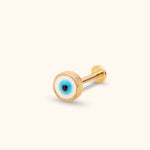 Gold-toned stud with a round white, blue and black evil eye face, straight post and flat disc back on a cream background.