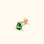 Gold-toned piercing stud with a faceted green teardrop-shaped stone in a prong setting and a round flat back.