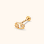 Gold-toned Cancer zodiac stud with an openwork symbol, straight post and round flat back, shown diagonally on a cream background.