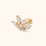 Gold-tone stud earring with five clear pear-shaped stones in a fan-like cluster and a flat disc back on a cream background.
