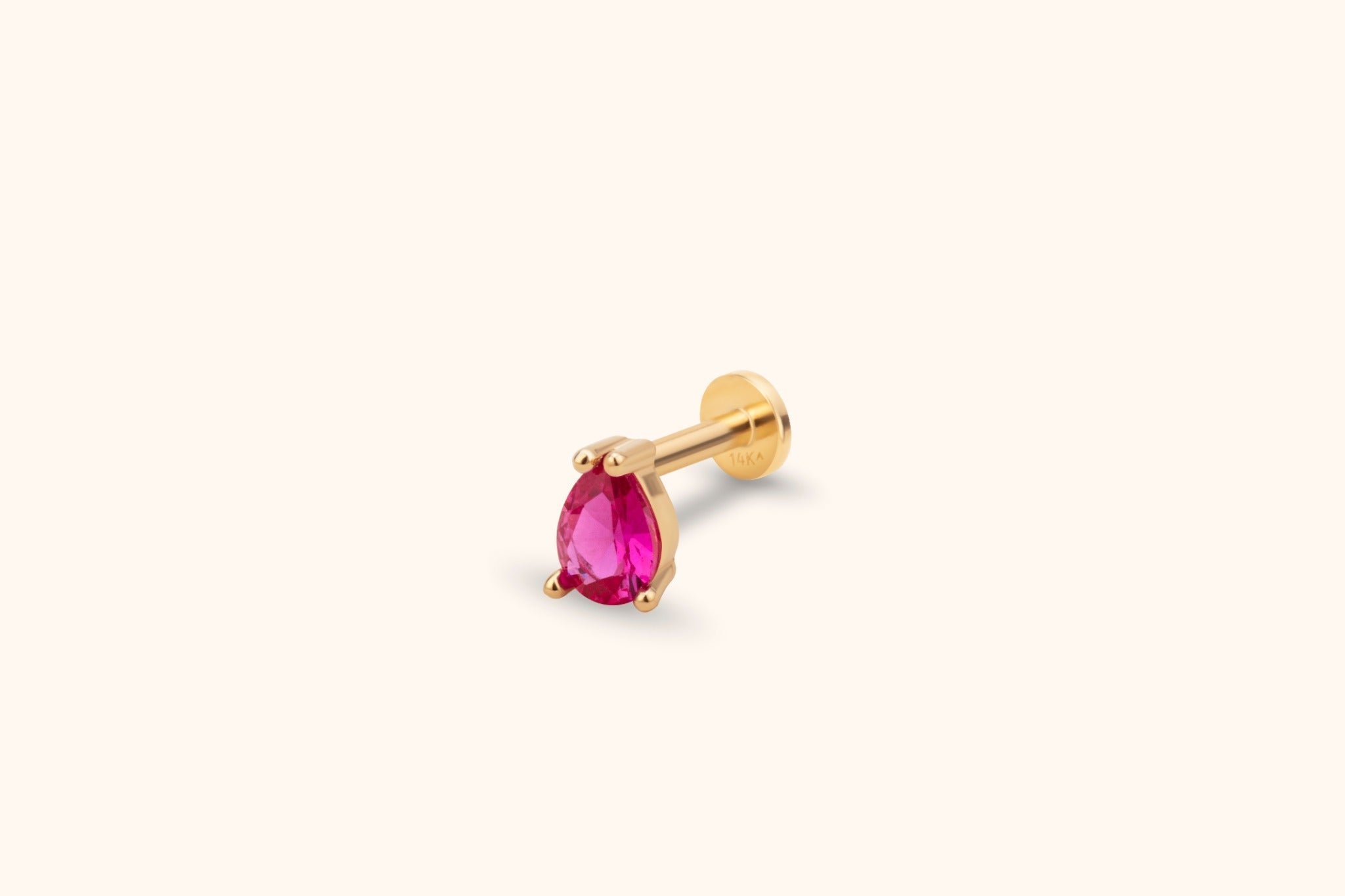 Gold-toned piercing stud with a faceted pink teardrop stone in a prong setting, a straight post and a flat round back.