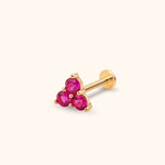 Gold-colored flat-back stud with three round, faceted pink stones in a triangular cluster on a cream background.