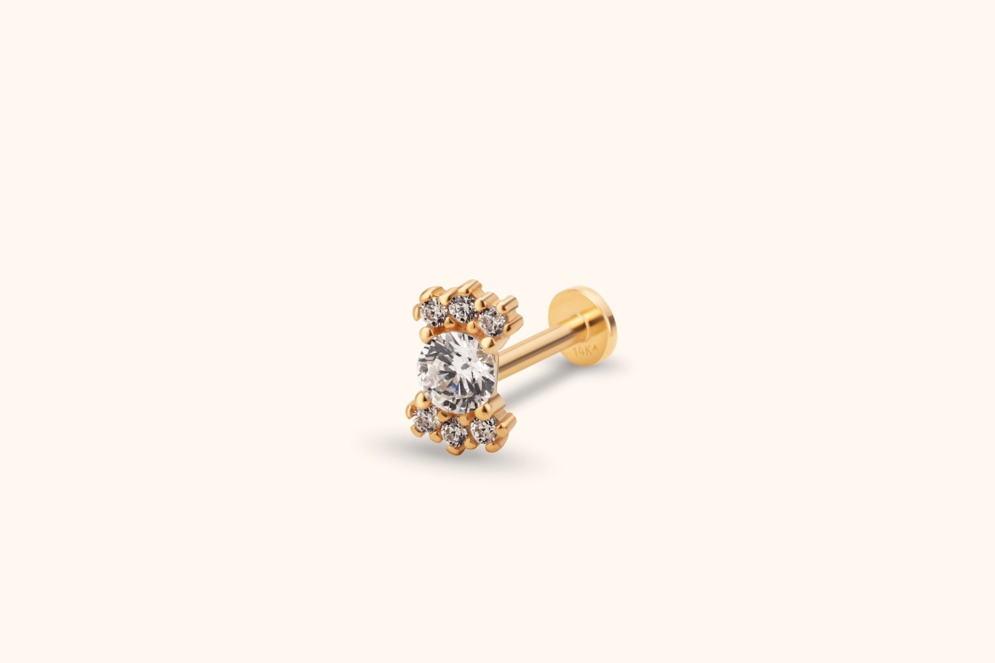 Gold-tone flat-back stud with a large round clear stone and two clusters of three smaller clear stones above and below.