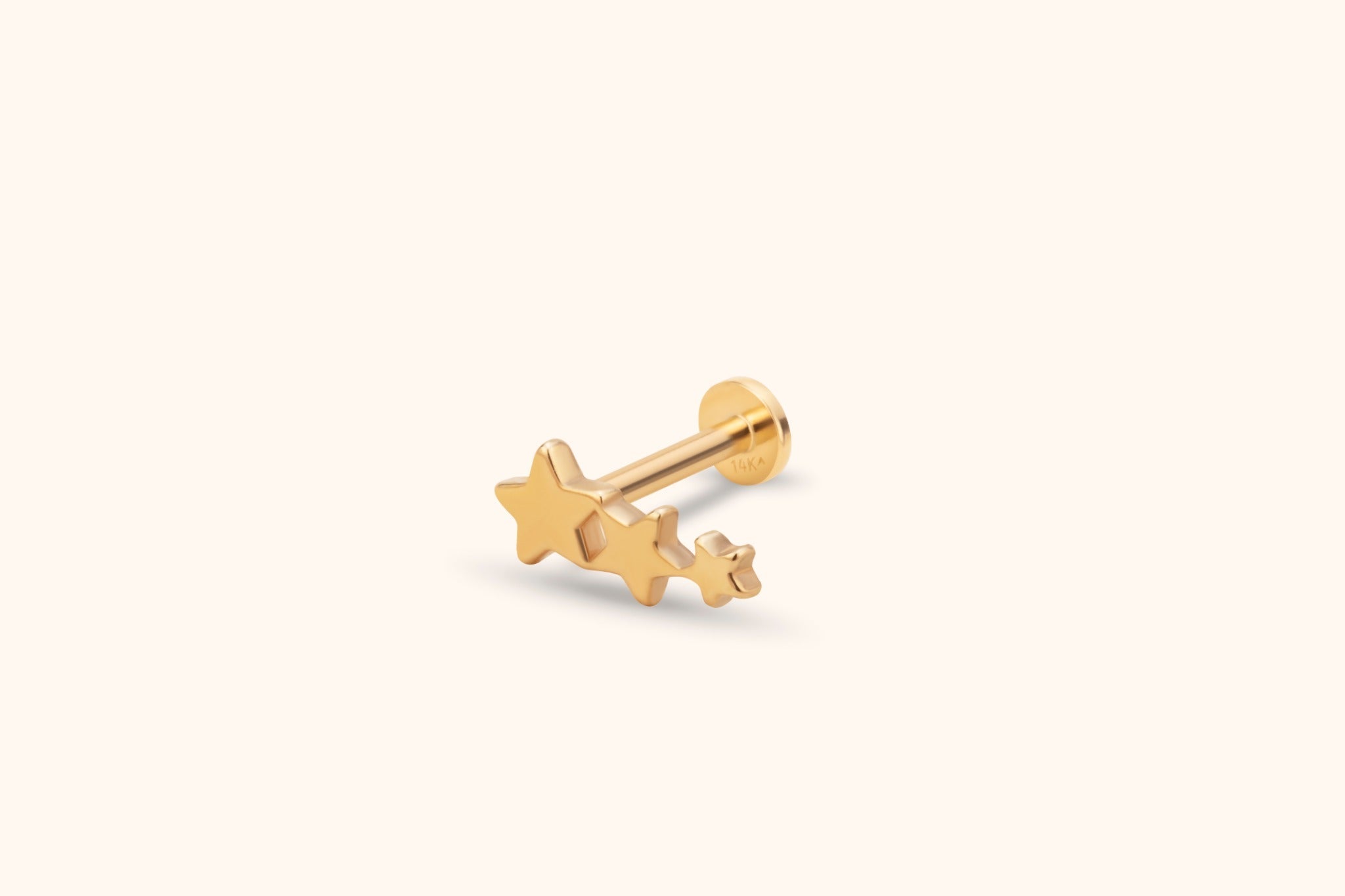 Gold-colored stud earring with three connected stars in decreasing sizes, a straight post and a flat round back.