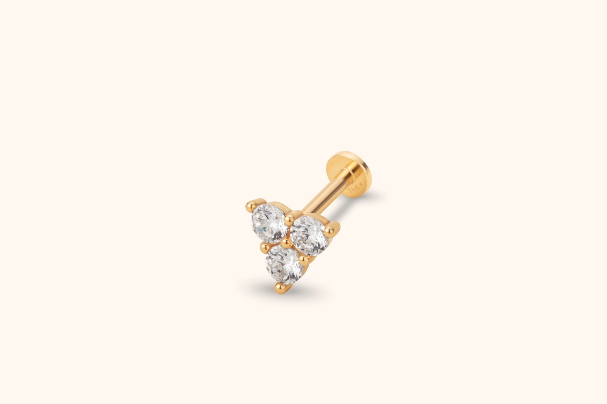 Gold-toned stud earring with three round clear stones in a triangular cluster, a straight post and a flat circular back.