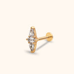 Gold-tone flat-back stud with a clear rectangular stone between two teardrop-shaped stones, shown at an angle on a cream background.
