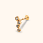 Gold-colored stud with four round clear stones in a staggered vertical row, a straight post and a flat circular back.