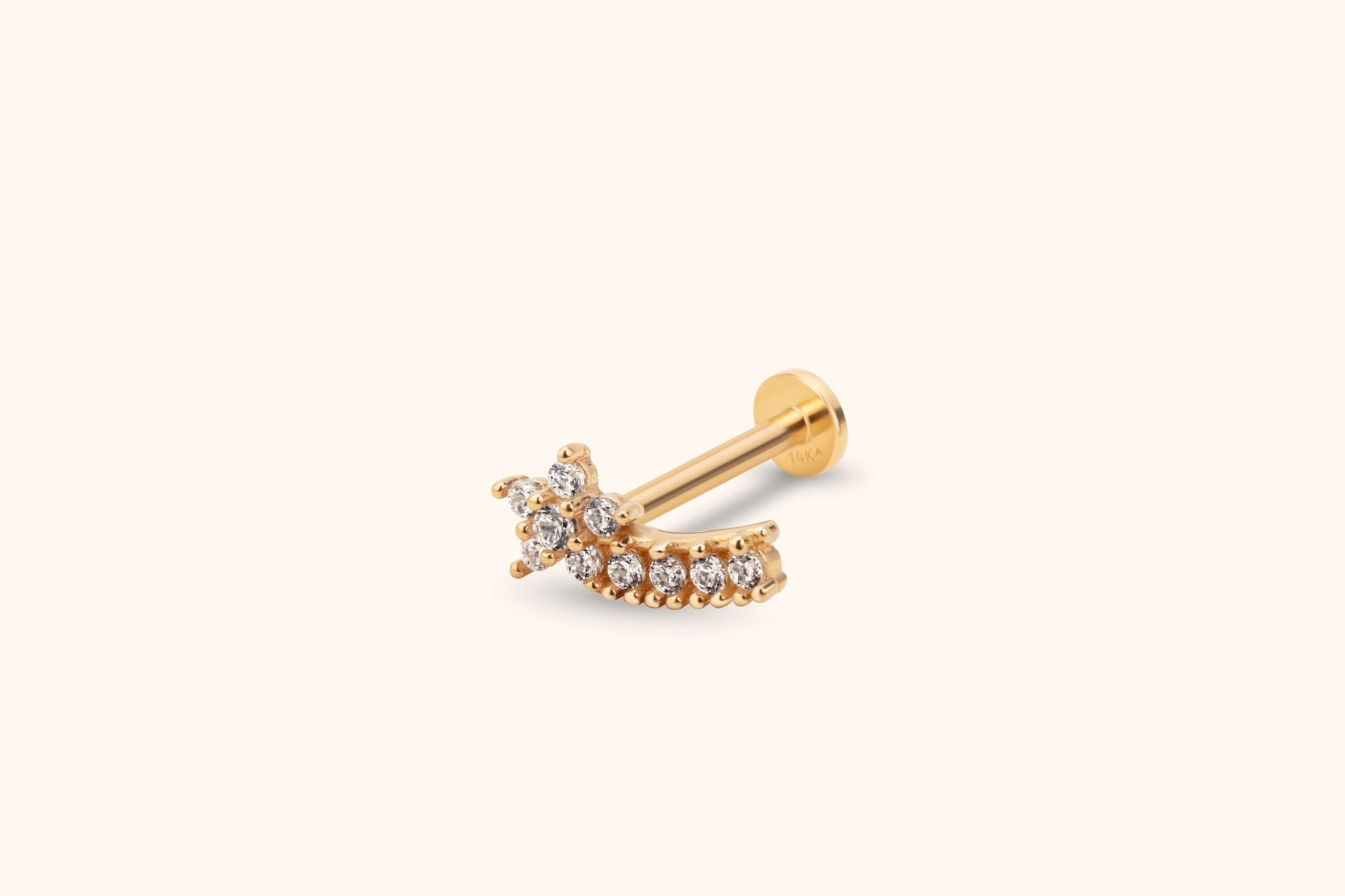 Gold-toned stud earring with a clear stone cluster, curved row of round clear stones, straight post and flat disc back.